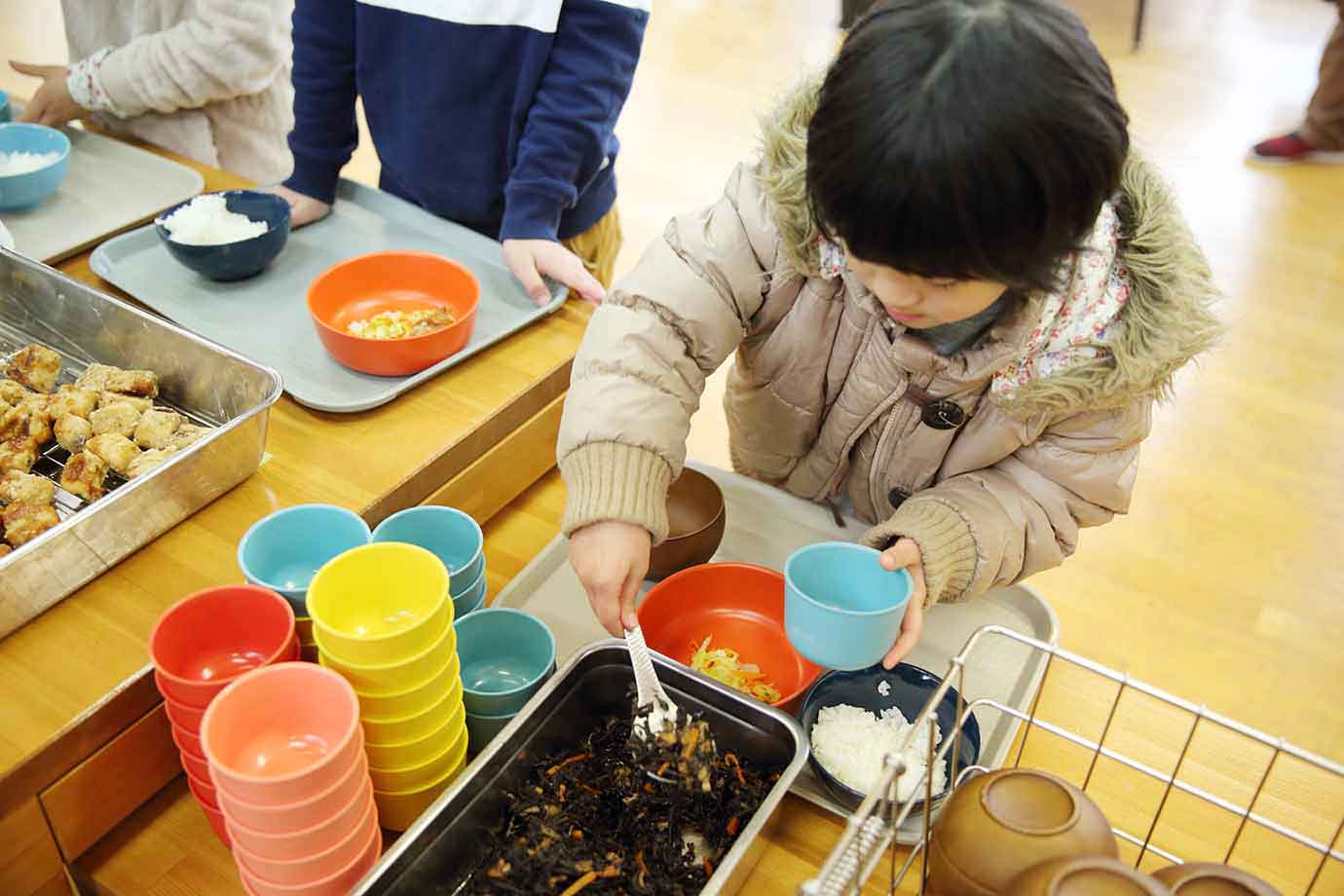 小学校1年生の児童も、好きな器を選び、食べられる量を考えながら盛り付ける